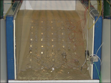 Experiments on micro-instability in slopes of granular soils.